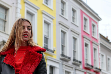 model in red coat in the colorful streets of london