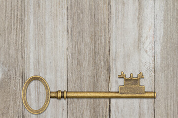 Old retro skeleton key on weathered wood