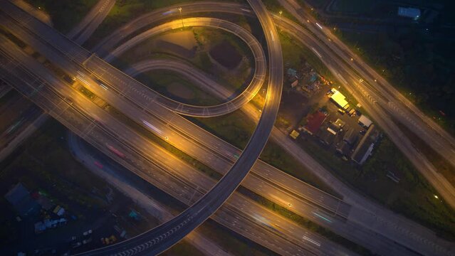 4K : Time lapse Aerial view and top view of traffic on city. Expressway with car lots. Beautiful roundabout road in the city center. Hyperlapse aerial top view from drone
