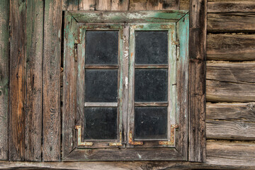 Fototapeta na wymiar Rustic style aged window in rural home wall.