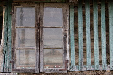 Rustic style aged window in rural home wall.
