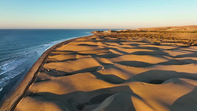 Sand dunes meet the Atlantic Ocean. Top view of Maspalomas sand dunes.