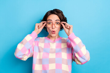 Photo of young pretty woman astonished hands touch spectacles face reaction stupor isolated over...