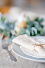 Beautiful eco-friendly table setting with candles and napkins.