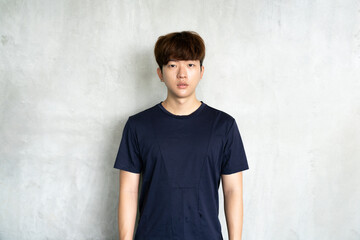 Asia young man on gray background and looking at camera. Casual young man.