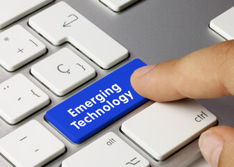 Emerging Technology - Inscription on Blue Keyboard Key.
