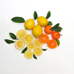 Citrus set from fresh mandarins and lemons with leaves and slices on white background.Free space for writing.Top view