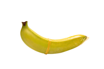 A banana with a condom on it isolated on white background.