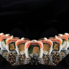 sushi rolls on black background © Omelia