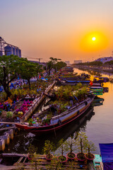 Springtime in Saigon, boat on canal, transport spring flower for Tet to Ben Binh Dong open air...