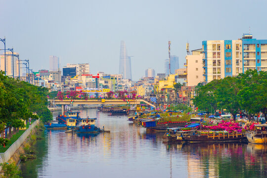 Springtime in Saigon, boat on canal, transport spring flower for Tet to Ben Binh Dong open air market, Vietnamese happy with Lunar New Year, Vietnam