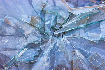Broken glass on the ground, dirty shards of glass