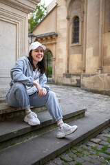 woman posing in baggy sport cloth outdoors