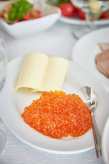 Red caviar on a plate. Vertical frame.