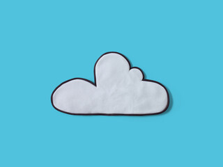 White fluffy cloud made of plasticine, isolated on a blue background