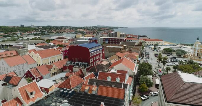 Willemstad downtown is the capital city of Curaçao, a Dutch Caribbean island.
aerial view  features brightly painted colonial buildings and colorful roofs