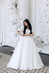 Bride in a white dress in the ceremonial hall. Getting ready for the upcoming wedding. Significant date.