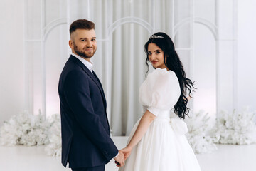 The bride and groom in the ceremony hall. The newlyweds congratulate each other. A significant day.