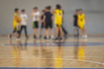 View of basketball court hall indoor venue with junior teenage school team playing in the background, basketball match game on arena stadium, team is blurred with copy space