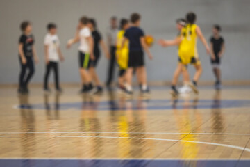 View of basketball court hall indoor venue with junior teenage school team playing in the...