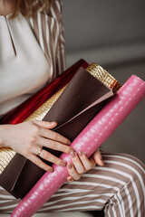 Scrolls with cover materials in the hands of a business woman 4135.