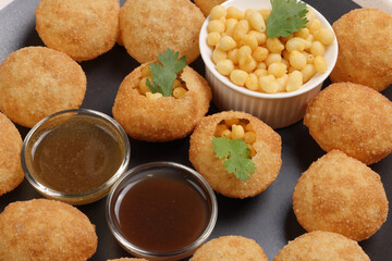 Tadeonal subcontinental street snack food boondi chickpeas potato Dahi Puri Chaat pani puri fuska set with chutny sauce