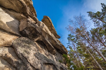 Autumn landscape with trees and rocks on top of a mountain against the sky