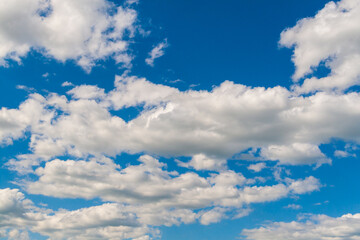 Obraz premium White clouds cross the blue sky. Summer sky with white clouds.