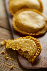 Ecuadorian empanadas de verde served on typical and wooden plates with a rustic and traditional atmosphere