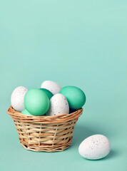 White and green Easter eggs in a basket