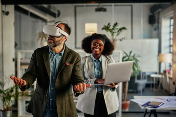 Business persons with virtual reality headset and laptop in the office