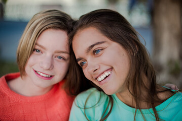 Two smiling girls. Two friends. Happy female students having fun together. Two young girls in the evening outside