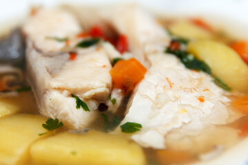 Traditional savory hot fish soup served hot on a plate for lunch