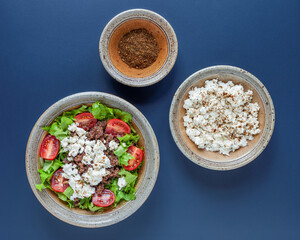Fresh salad with whole grain teff, cheese and mitmita spice blend. Ethiopian cuisine.