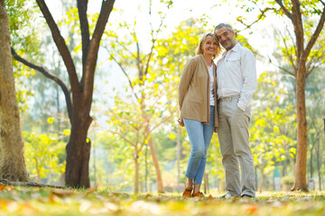 Portrait of happy elderly couple take care and love with good relationship health and romantic in the park as retirement insurance and lovely couple concept