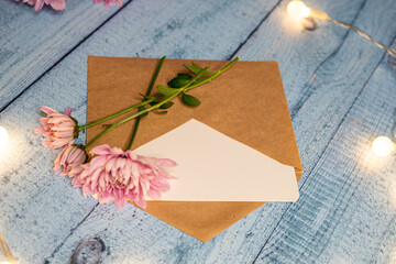 postcard envelope wooden table and chrysanthemums