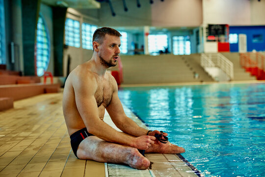 Thoughtful disabled man sitting by the pool