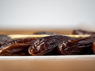 Juicy dates in a package with a wooden fork.