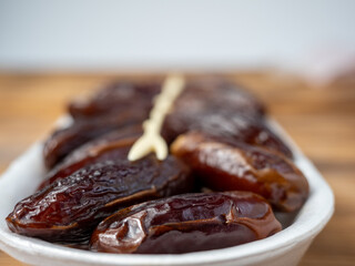 Juicy dates in a package with a wooden fork.