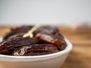 Juicy dates in a package with a wooden fork.
