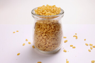 Deep fried crunchy spicy lentils moong dal fry in small glass jar