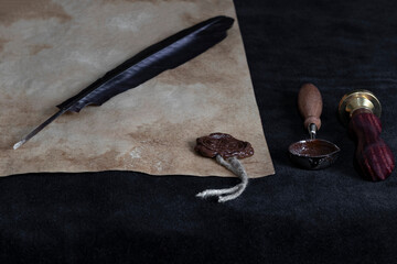 Ancient paper scrolls sealed with a seal on an old map. Pen for writing.