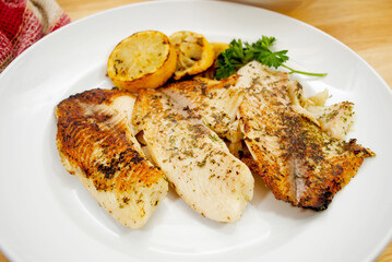Fresh Tilapia Cooked with Butter and Herbs, Served with Lemon Slices 
