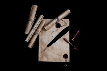 Ancient paper scrolls sealed with a seal on an old map. Pen for writing.