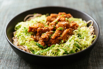 Spicy soy curls on shredded savoy cabbage, served with buckwheat noodles.