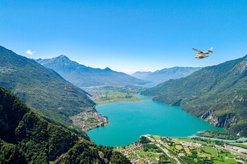 seaplane in flight over lake of Novate Mezzola in Valchiavenna, Italy - 487615511