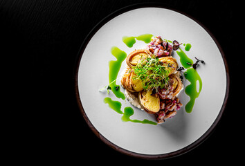 fried thin pancakes crepe stuffed potato with herring fish in plate 