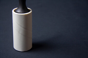Sticky roller for dusting clothes. Removing the dirt