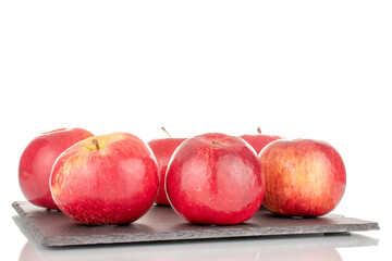 Several juicy, ripe, red apples on a slate stone, macro, isolated on a white background.
