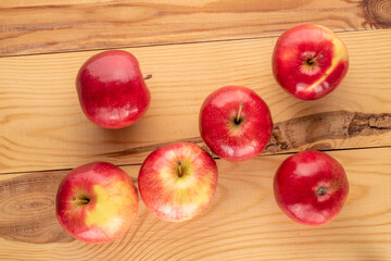 Some sweet organic, red apples  on a wooden table, macro, top view.